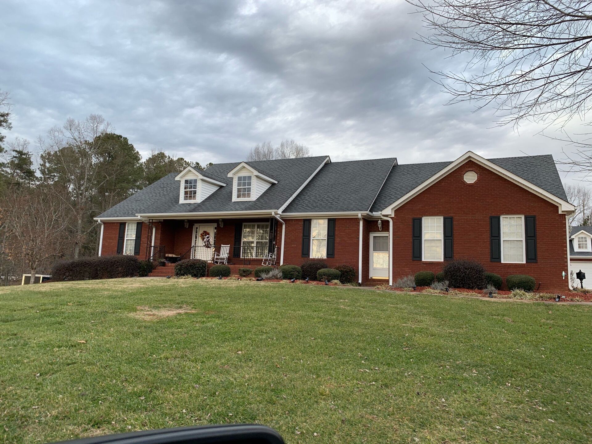 Residential roof work in progress with new underlayment and shingle installation